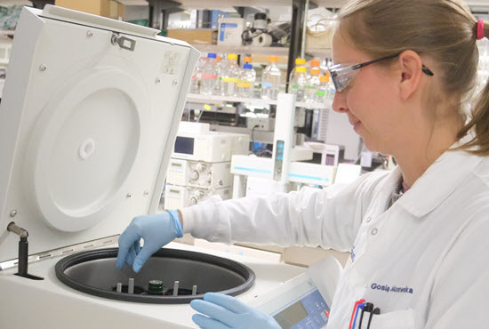 faculty in white lab coat in a lab